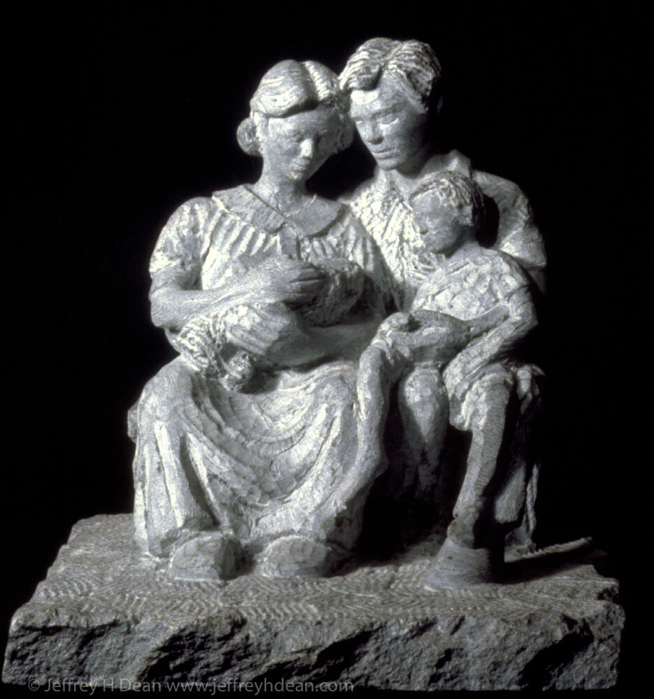 Stone carving of family with newborn child