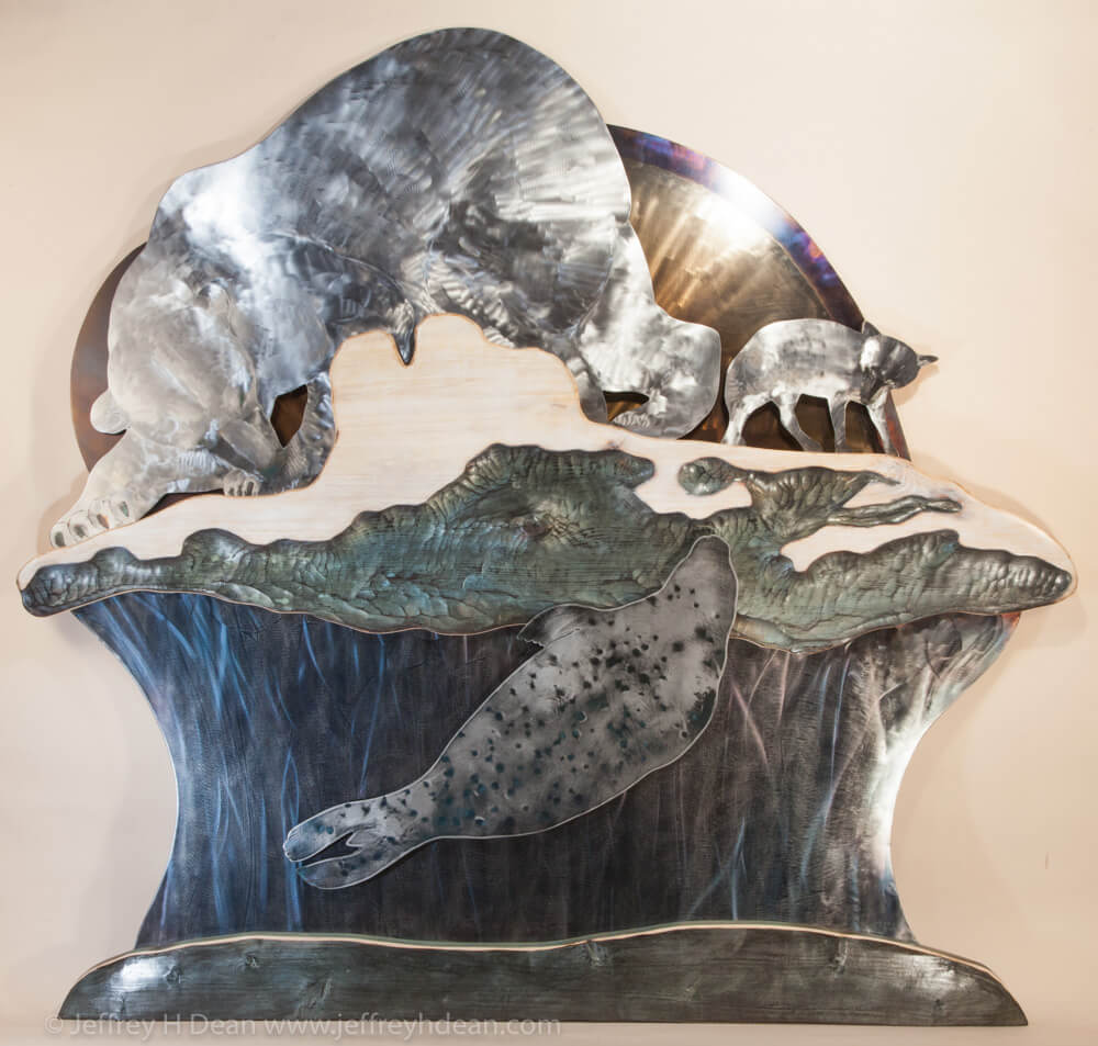 A lone polar bear and arctic fox watch silently as a seal rises to it's breathing hole in this layered metal and wood wall art.