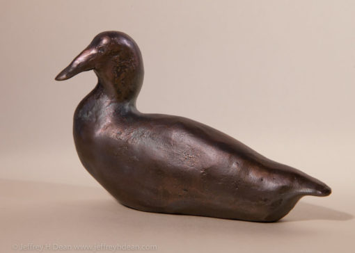 Small bronze duck sculpture