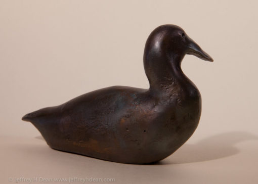 Small bronze duck sculpture