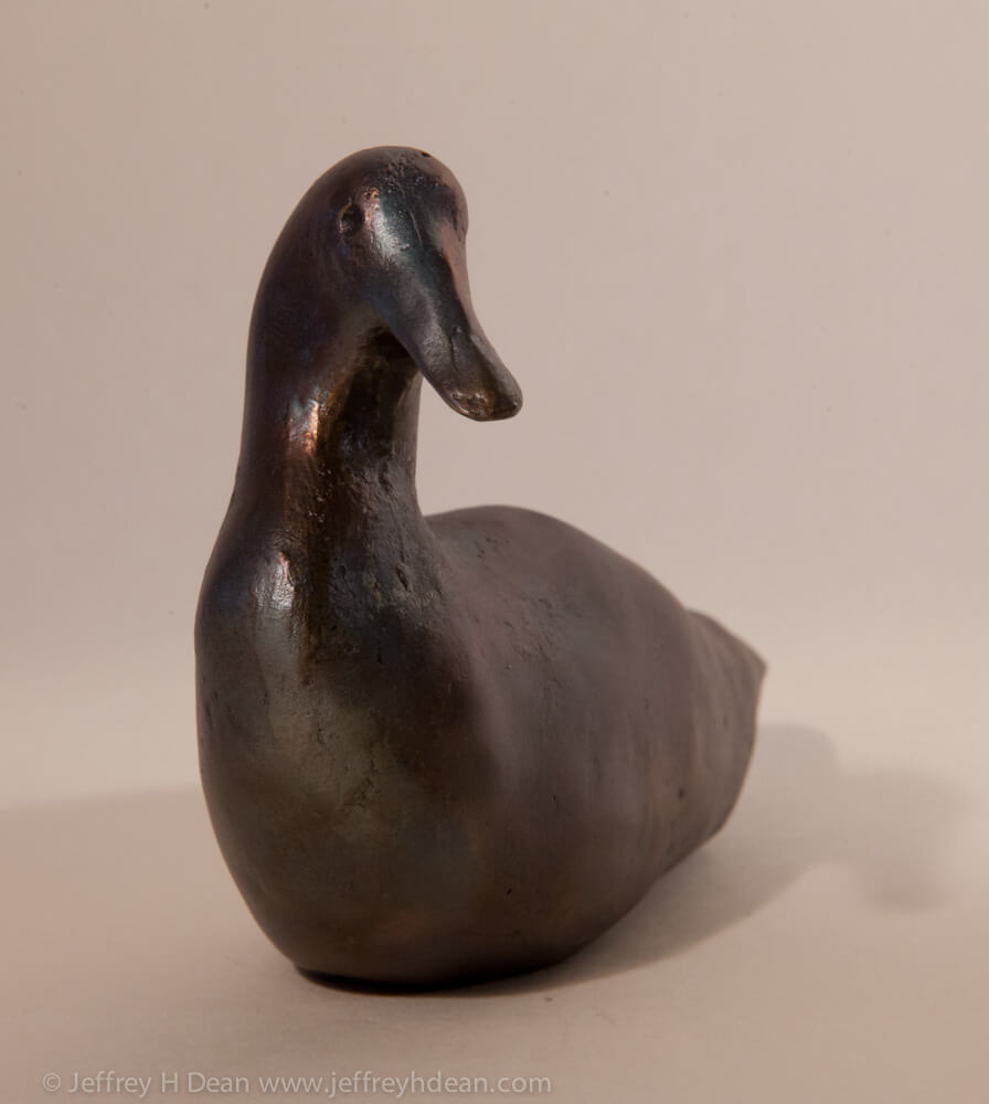 Small bronze duck sculpture