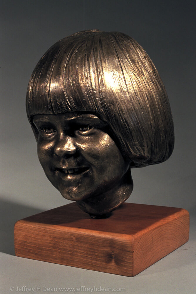 Bronze portrait of a young girl.