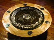 Metal wall art used as a decorative coffee tabletop. Denali National Park; the mountains, rivers, animals and animal tracks. Engraved steel saw blade with heat tints.
