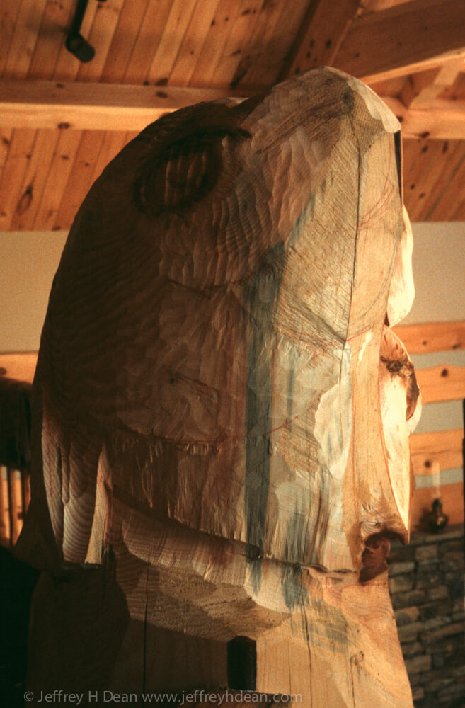 Carved golden eagle finial for structural timber in log house.