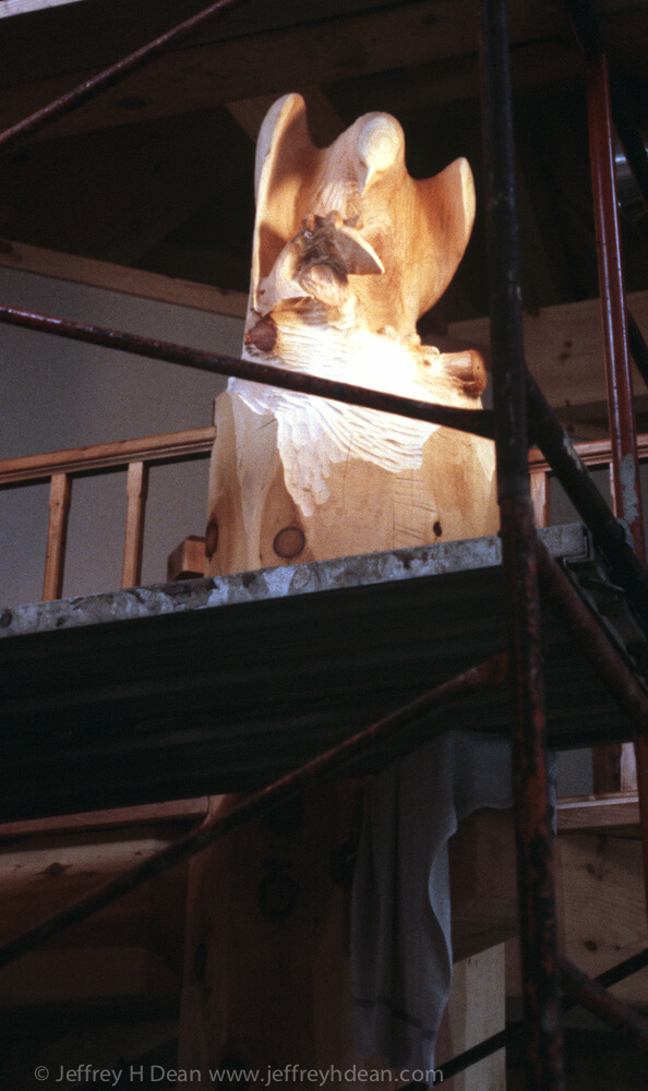 Carved golden eagle finial for structural timber in log house.