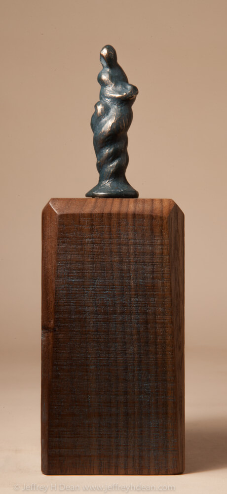 Bronze miniature sculpture of a figure in the form of gathering storm clouds.