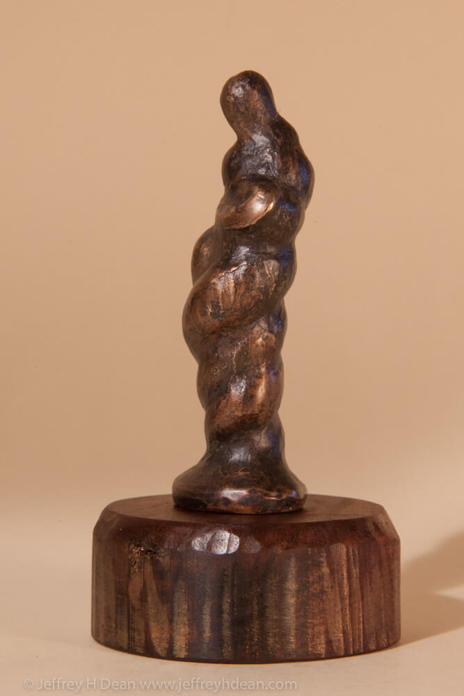 Bronze miniature sculpture of a figure in the form of gathering storm clouds.