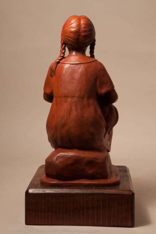 Bronze sculpture of a young girl holding her rooster.
