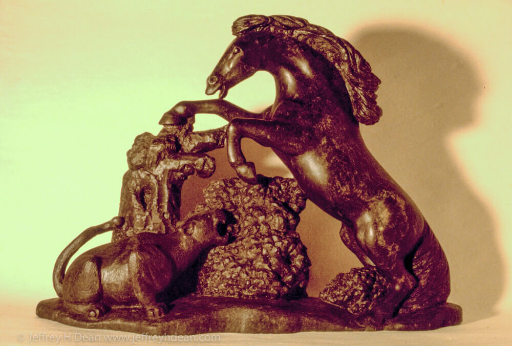 Soapstone carving of rearing horse and mountain lion.