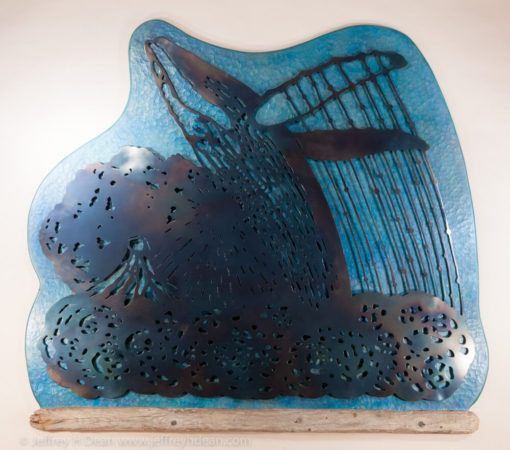 A humpback whale breaches in front of Mt. Augustine sunset in this wood and metal wall art
