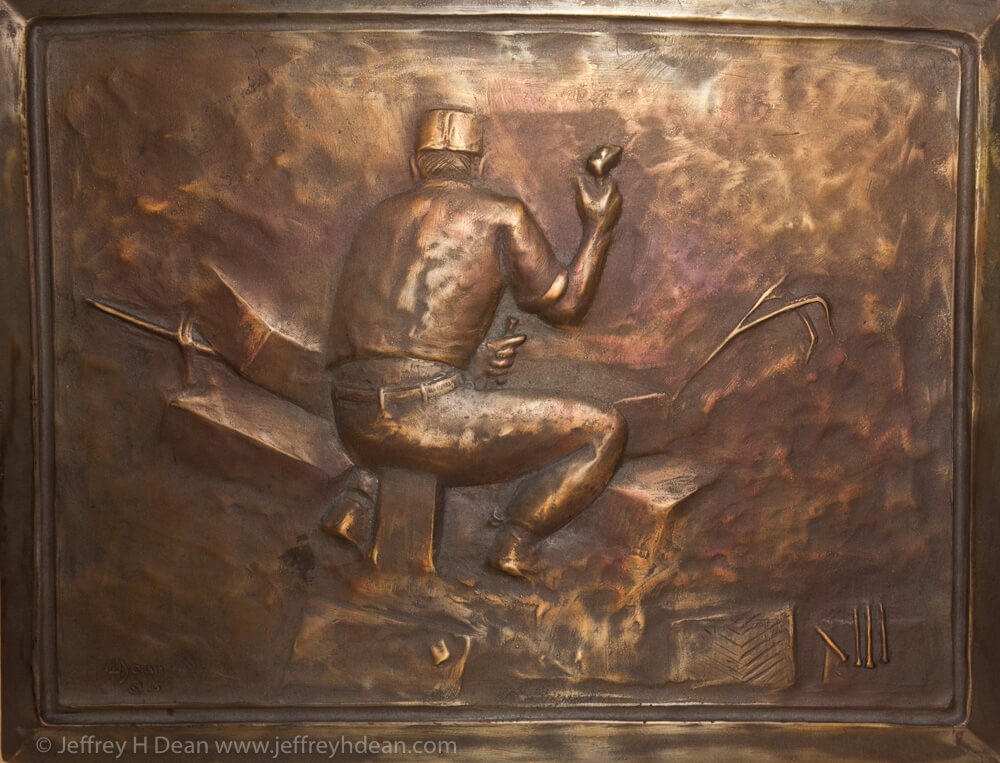 Bronze relief of Italian flagstone carver in Florence, Italy.