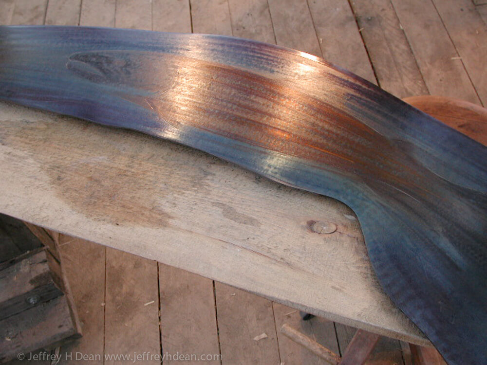 Lifecycle in salmon stream. Engraved steel with heat tints on cherry table.