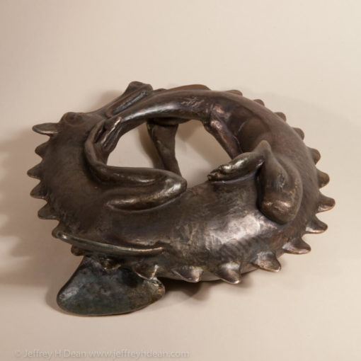 Sleeping baby dragon in bronze.