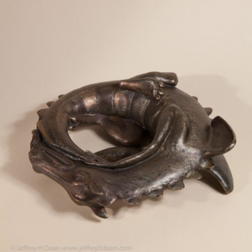 Sleeping baby dragon in bronze.